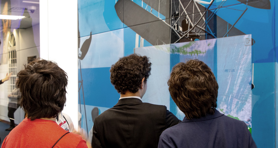 Students using an interactive touch screen in Innovation Corridor.